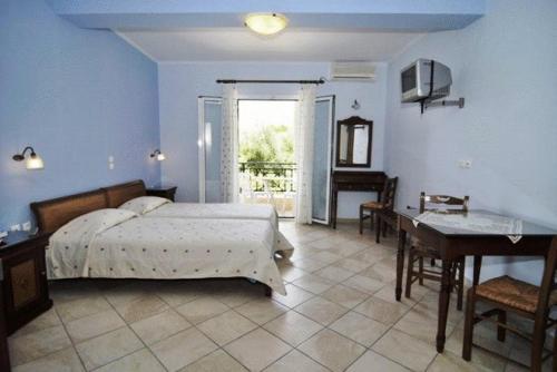 a bedroom with a bed and a table and a desk at Dias Studios in Pythagoreio