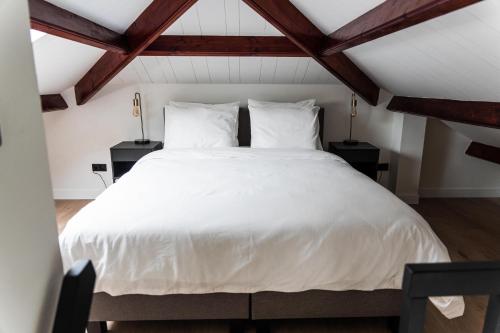 מיטה או מיטות בחדר ב-Bed en Wellness Groenrust