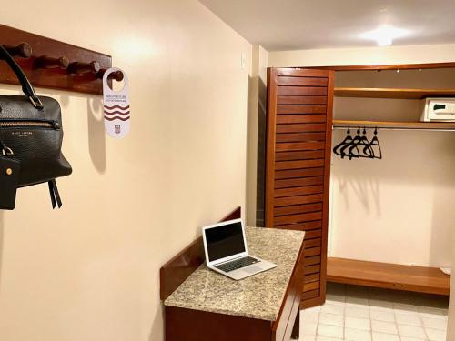 a laptop computer sitting on a counter in a room at Kastel Manibu Recife - Boa Viagem in Recife