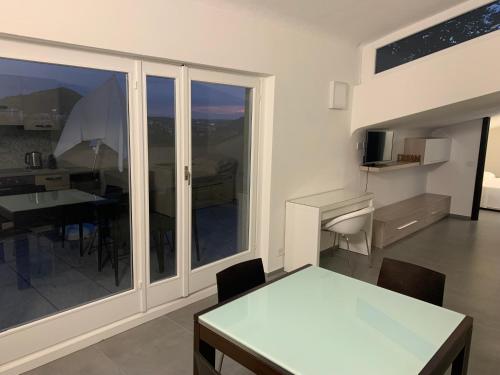 a dining room with a table and a view of a room at Volta's Dream in Como