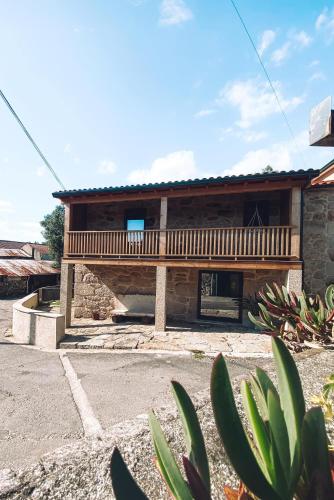a house with a balcony on the side of it at Casa Azevedos in Ponte da Barca