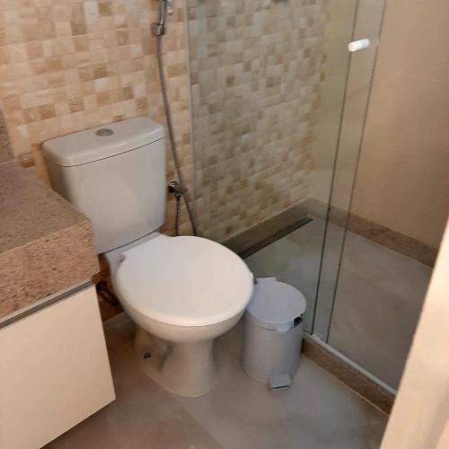 a bathroom with a toilet and a shower at Apartamento Mania in Vitória