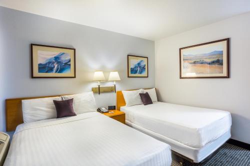 a hotel room with two beds in a room at Knights Inn and Suites Yuma in Yuma
