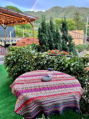 a table with a blanket on top of it at Impronte Nel Bosco in Calice al Cornoviglio