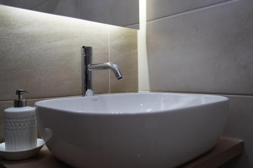 a white sink with a faucet in a bathroom at MERAVIGLIA in Parga