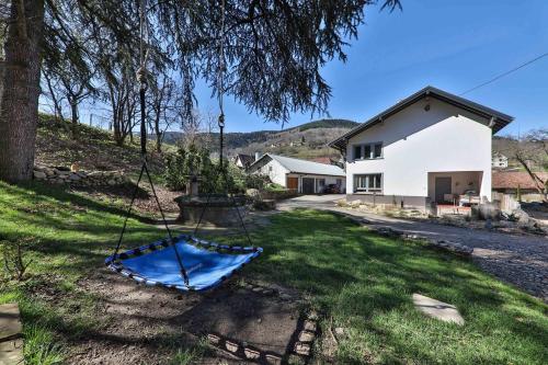 a swing in the yard of a house at Locations des 3 sommets avec Sauna et Spa en Alsace in Sondernach