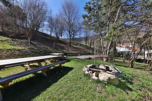 a group of picnic tables in a park at Locations des 3 sommets avec Sauna et Spa en Alsace in Sondernach