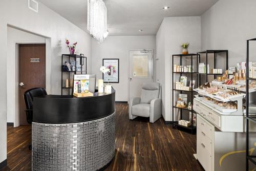 a cosmetics salon with a counter and a chair at Home Inn & Suites - Swift Current in Swift Current