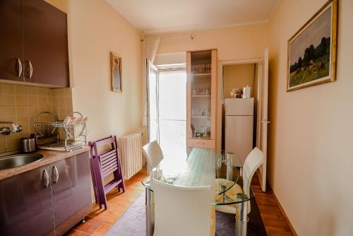 a kitchen with a glass table and a refrigerator at Apartment Petra 071 in Belgrade