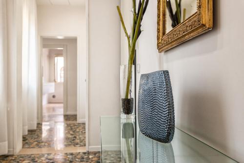 a vase with a plant in it in a hallway at Casanova Fenice - Canal View in Venice