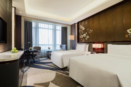 Ένα ή περισσότερα κρεβάτια σε δωμάτιο στο Wanda Realm Yinchuan