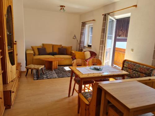 a living room with a couch and a table at Eselgut in Hofkirchen im Mühlkreise