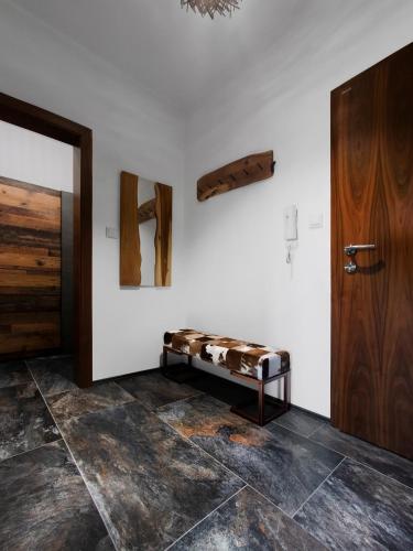 a room with a bench next to a door at TatryView Apartments by KingDubaj in Veľká Lomnica