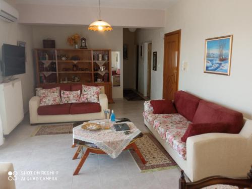 a living room with two couches and a coffee table at BELLA-CAZA in Mákri