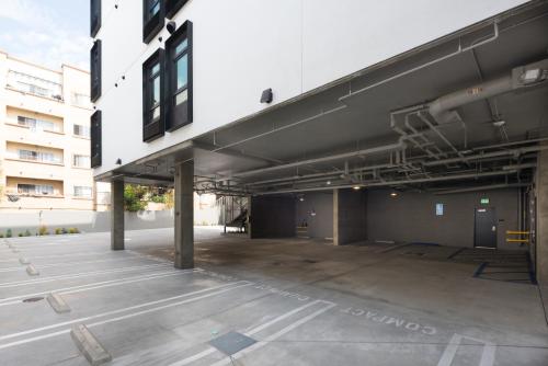 an empty parking lot in front of a building at The Metric - Los Angeles Downtown in Los Angeles