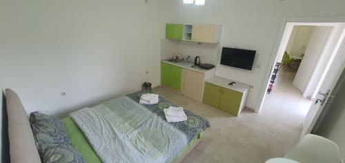 a small room with a bed and a kitchen at Antonio Apartments in Ohrid