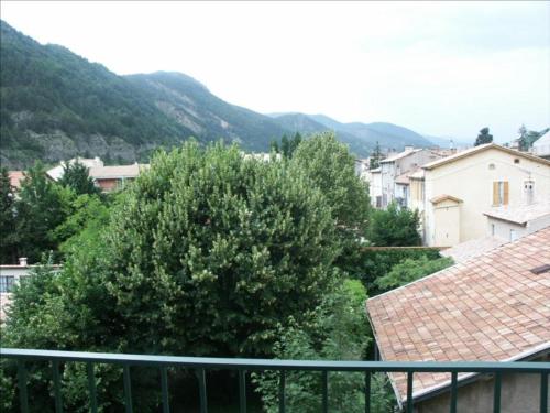 a view of a city with a tree and houses at Superbe studio résidence le Galion 81 in Digne-les-Bains