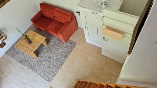 an overhead view of a living room with a red chair at Rehbrook in Süsel
