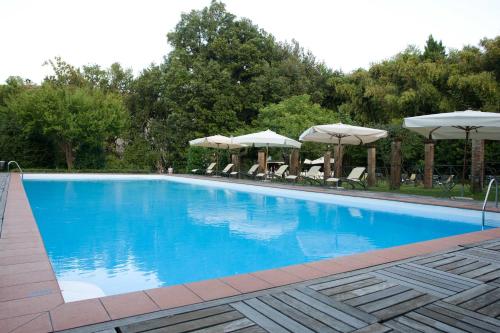 a large blue swimming pool with umbrellas and chairs at Hotel Villa La Principessa in Lucca