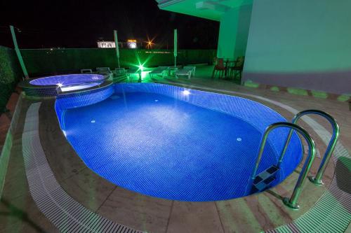 a large blue swimming pool at night at Huma Elite Hotel in Antalya
