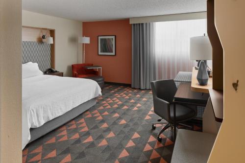 a hotel room with a bed and a desk at Holiday Inn Asheville - Biltmore West by IHG in Asheville