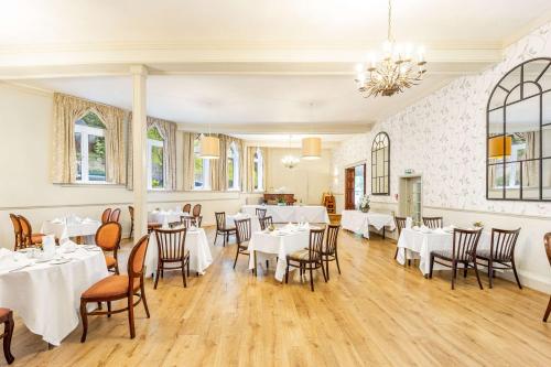 a dining room with white tables and chairs at Best Western Limpley Stoke Hotel in Bath