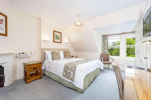 a bedroom with a bed and a fireplace at Best Western Walton Park Hotel in Clevedon