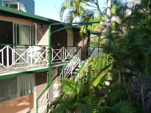 a balcony of a building with palm trees at Yongala Lodge by The Strand in Townsville