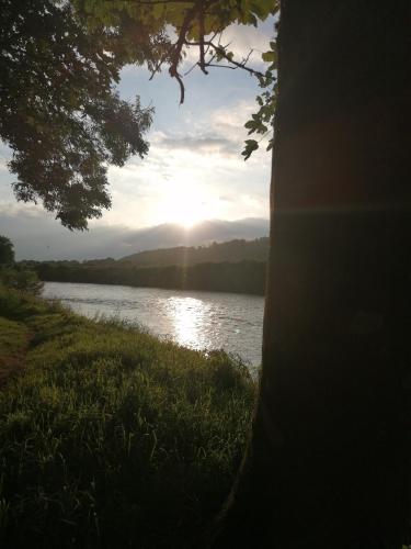 a view of a river with the sun setting at Cable Island Bed and Breakfast in Cork