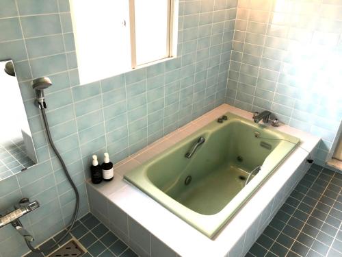 a green tub in a bathroom with a window at New Open!!! BRIDGE 小浜島 in Kohama