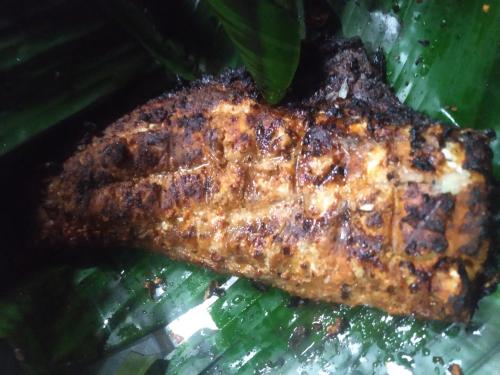a piece of meat sitting on a green leaf at Jayuz Homestay & Foodies in Kozhikode