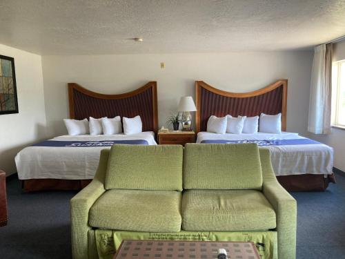 A bed or beds in a room at Days Inn by Wyndham Capitol Reef