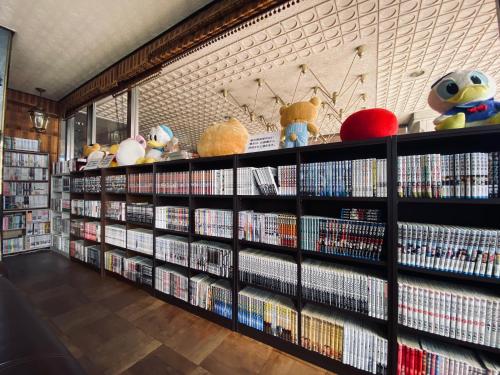 a library with shelves filled with dvds at Hotel Los Inn Kochi in Kochi