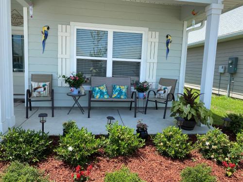 a front porch with chairs and a table with birds on it at Beach Room, for wonderful Vacation in Panama City Beach
