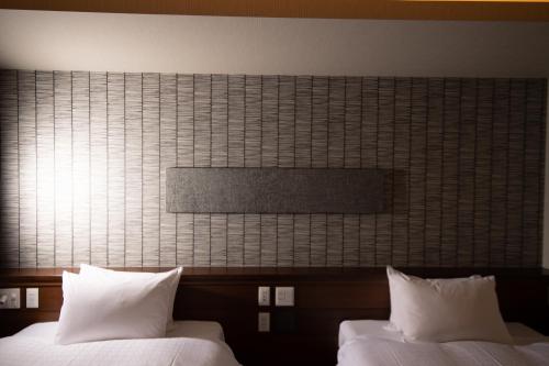 Ένα ή περισσότερα κρεβάτια σε δωμάτιο στο Hotel Celeste Shizuoka