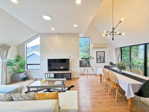 a living room with a couch and a table at Queenstown Lakeview Holiday Home-5mins to town in Queenstown