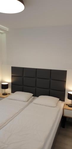 Ένα ή περισσότερα κρεβάτια σε δωμάτιο στο Porta Mare Apartamenty Słoneczne Tarasy