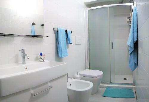 a bathroom with a sink and a toilet and a shower at Green Holiday Villa in Bibione
