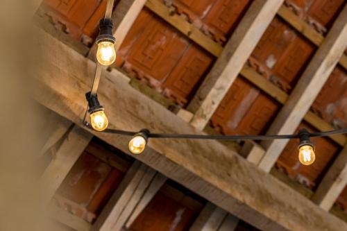 a group of lights hanging from the ceiling of a building at De Hoeveschuur in Riemst