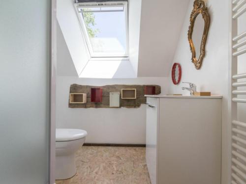 a bathroom with a toilet and a window at Gîte Varades, 3 pièces, 6 personnes - FR-1-306-847 in La Chapelle-Saint-Sauveur
