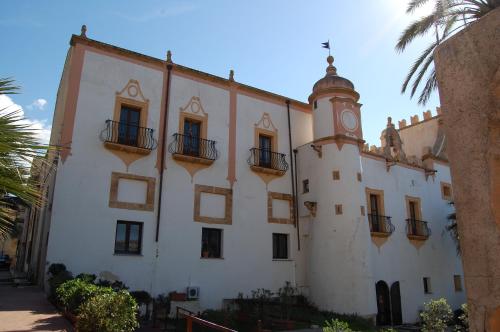 a building with a clock tower on top of it at Cinisi 89 B&B in Cinisi