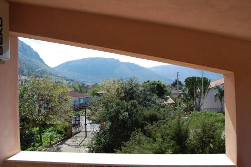 a window in a building with a view of a mountain at Cinisi 89 B&B in Cinisi