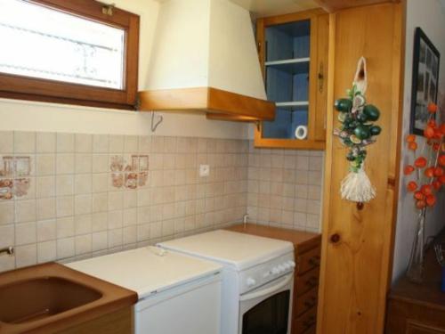 a kitchen with a sink and a stove top oven at Gîte Xonrupt-Longemer, 3 pièces, 4 personnes - FR-1-589-204 in Xonrupt-Longemer