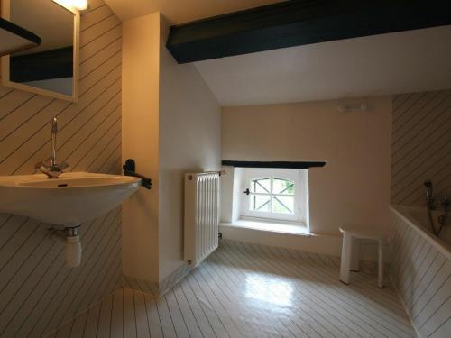 a bathroom with a sink and a window at Gîte familial avec grande terrasse à Auzat, proche baignades et sites historiques - FR-1-582-183 in Villeneuve-dʼAllier
