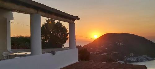 a sunset from a house with a mountain in the background at Casa tra Cielo e Mare in Lipari