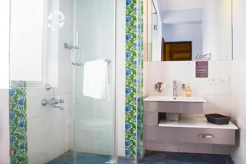 a bathroom with a sink and a shower at Orchid Suites - A Boutique Hotel Bangalore Off Residency Road in Bangalore