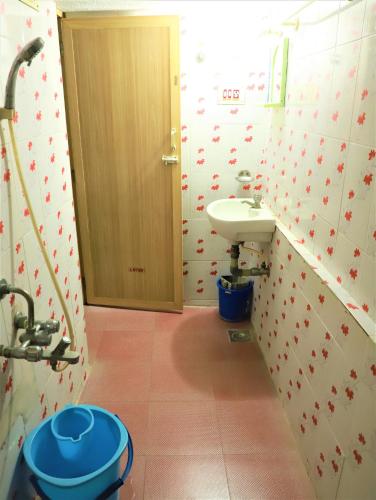 a bathroom with a sink and a toilet at Just Guest House, Chennai Airport in Chennai