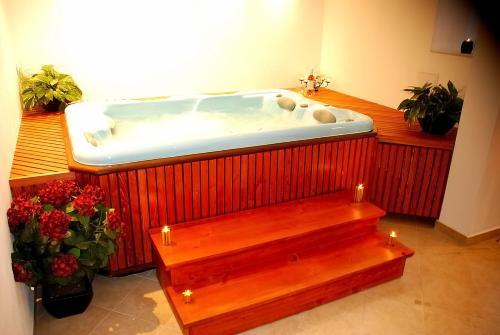 a large bath tub in a room with flowers at Guest House Ela in Bansko