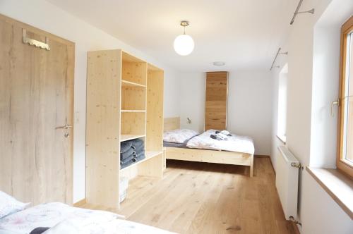 a bedroom with two beds and a closet at Ferienwohnung Litzlhof in Itter