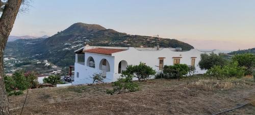 a church on a hill with a mountain in the background at Casa tra Cielo e Mare in Lipari